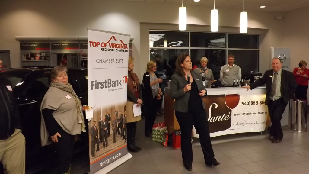 Business professionals networking at Tri-State Nissan during the Winchester Chamber of Commerce Mixer