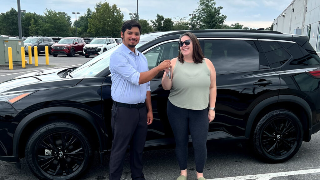 Tri-State Nissan customer Erin with Derek Nieves after purchasing her Nissan Rogue